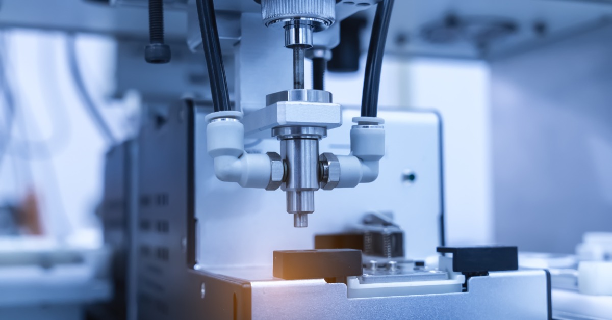 An automatic screw feeder in a cell phone assembly line. The equipment is ready to insert a screw into the device.