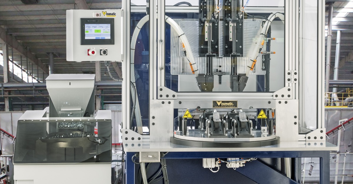 An automatic screw feeder inserting screws into devices at a phone assembly facility. The machine is clean and polished.